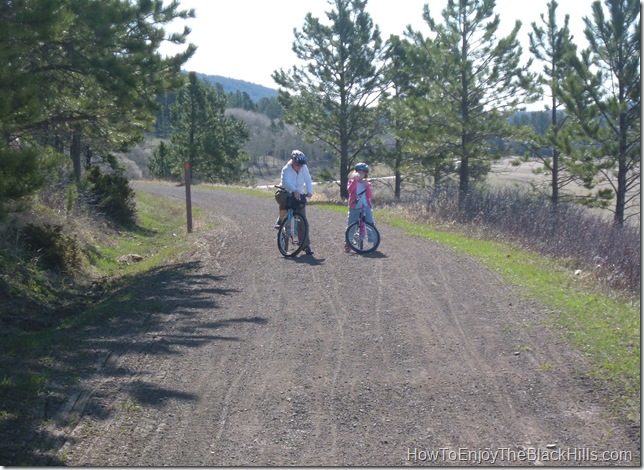 Two people stop to get a drink of water on the scenic Mickelson Trail in the Black Hills of South Dakota. It stretches 109 miles from Deadwood to Edgemont. image two bicycle riders on the George S Mickelson Trail in South Dakta